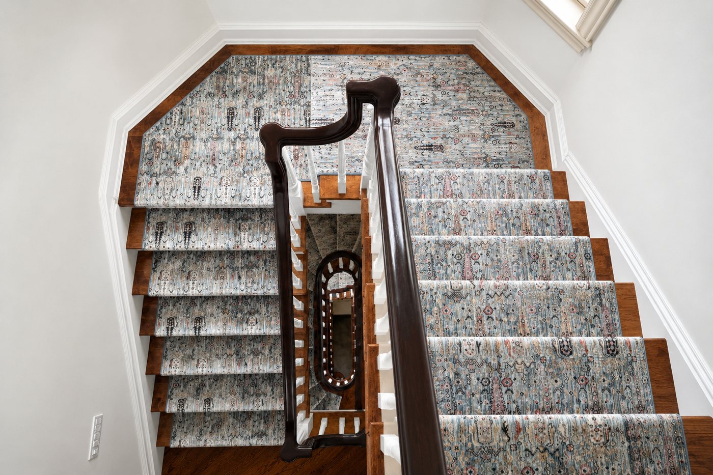 Patterned stair runner on a hardwood staircase